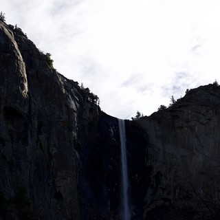 Dramatic Waterfall Between Towering Granite Cliffs at Dusk