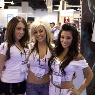 Three Women in White Shirts Strike a Pose