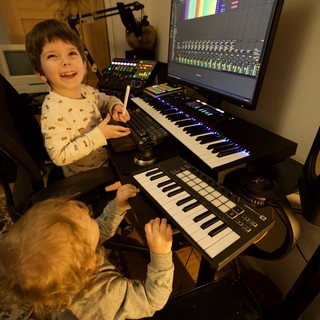 Young Brothers Making Music in Home Recording Studio