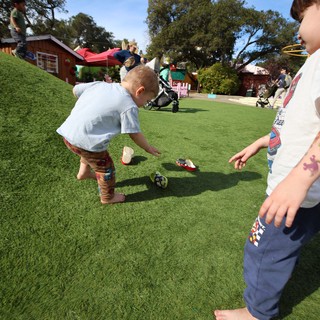 Children Playing Soccer in Sunny Park