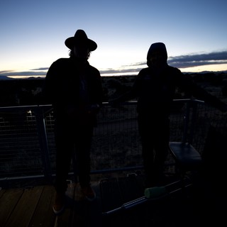 Twilight Contemplation: Silhouettes Against Desert Sunset