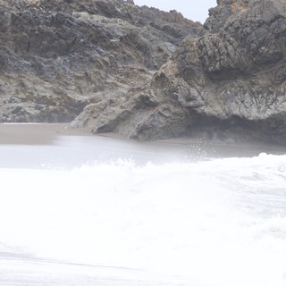 Crashing Surf Against Rugged Coastal Cliffs