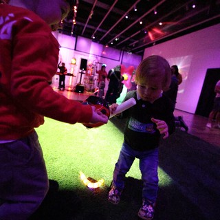 Child Dancing with Adult at Baby Rave Event