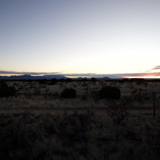 Desert Twilight Over Distant Mountain Ranges