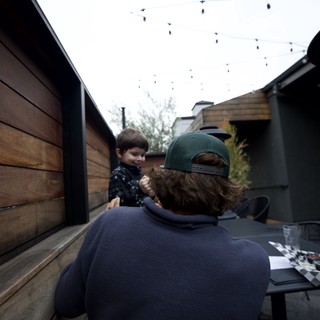 Father and Son Moment in Backyard Patio