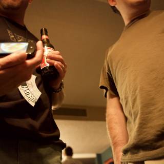 Two Men Texting and Drinking Beer