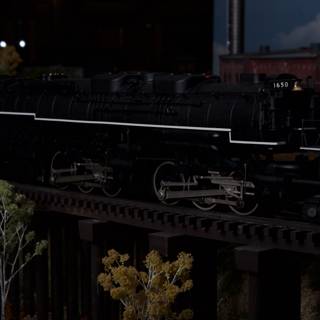 Black Locomotive Chugging Along the Railway