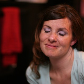 Contemplative Woman with Eyes Closed in Low Light