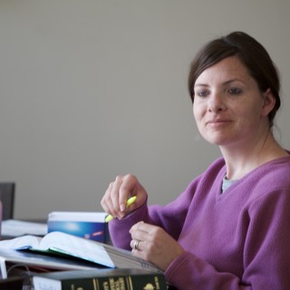 Woman Studying with Highlighter at Desk