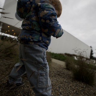 Young Child Running on Gravel Path at Dusk