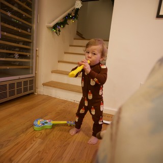 Toddler Playing Yellow Recorder on Christmas Morning
