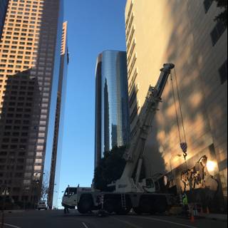 Construction Crane Lifting Equipment onto Office Building in Urban Metropolis