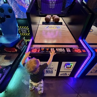 Young Child Playing NBA Arcade Basketball Game