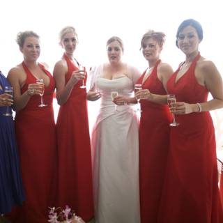 Red-Dressed Bridesmaids Toast to the Couple