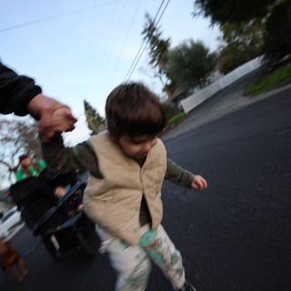 Child Running on Suburban Street at Dusk
