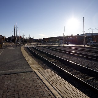 Sunlit Railroad Tracks Curve Through Santa Fe Station