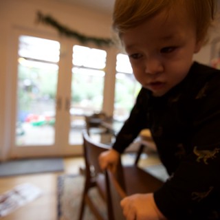 Curious Toddler with Red Hair Exploring at Home