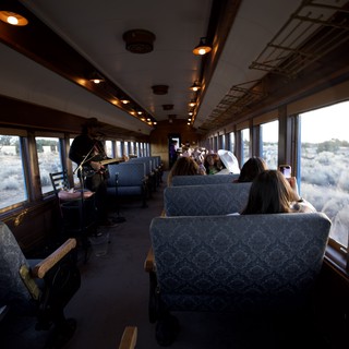 Vintage Train Journey Through Desert Landscape with Violinist