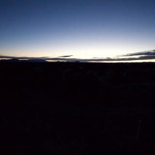 Desert Twilight Over Distant Mountain Silhouettes