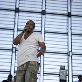 Entertainer Pharoahe Monch on stage in camo shorts and white shirt at Coachella 2007