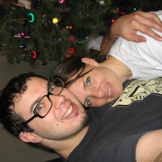 Holiday Cheer: Couple Poses by Christmas Tree
