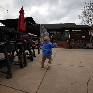 Toddler Exploring Outdoor Patio on Cloudy Day