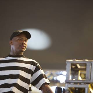 YG takes the stage in bold stripes and a cap