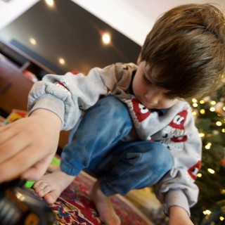 Child Opening Christmas Presents on Holiday Morning