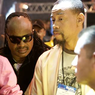 Two Men with Sunglasses at NAMM Convention Featuring Stevie Wonder