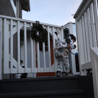 Child with Stuffed Animal on Winter Porch at Dusk