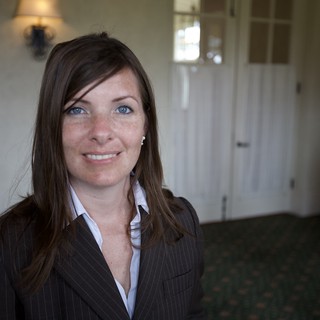 Professional Woman Smiling at a Funeral Reception
