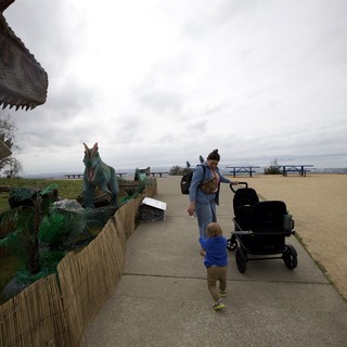 Child Encounters Dinosaur Exhibits at Hilltop Park