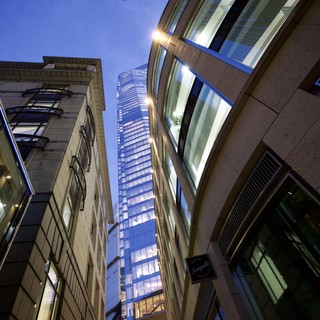 Modern Skyscraper Rising Between Historic London Buildings at Dusk