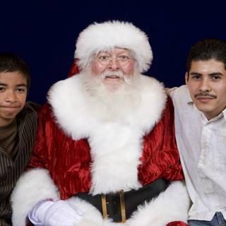 Santa Claus spreading joy with two boys at 2008 APC Xmas party