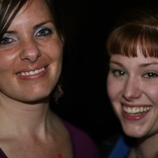 Two Young Women Smiling at a Nighttime Event
