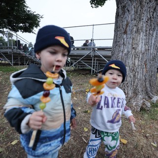 Two Young Brothers Enjoy Fruit Skewers at Balloon Festival