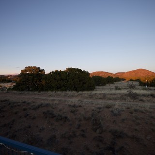 Desert Sunset Over Hills and Scrubland