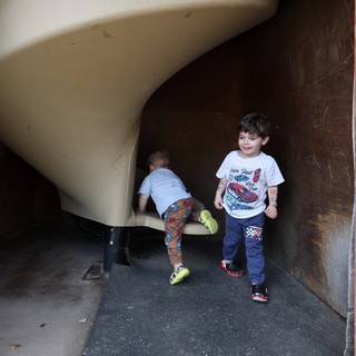 Children Playing on Curved Playground Slide at Dusk