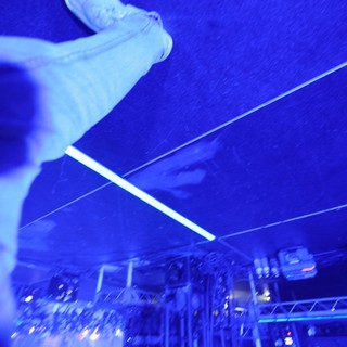 Crowd Surfer Soars Over Blue-Lit Festival Stage