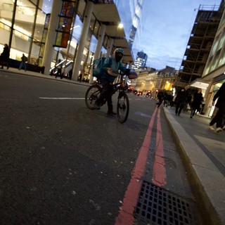 Evening Cyclist on London's Red Route at Twilight