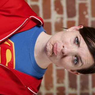 Supergirl Pouting Against Brick Wall Portrait