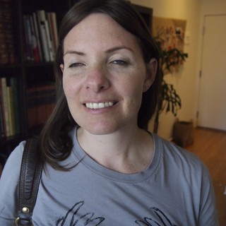 Smiling Woman with Dark Hair in Home Library