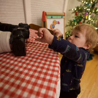Curious Toddler Exploring Camera on Christmas Morning