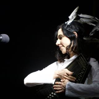 PJ Harvey Playing the Accordion with Feather Headpiece