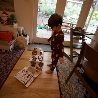 Toddler in Holiday Pajamas Playing with Puzzle at Home