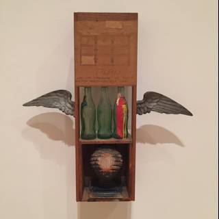 The Wooden Box with a Bird and a Bottle