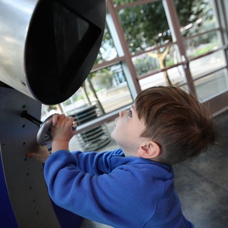 Young Boy Exploring Interactive Science Exhibit