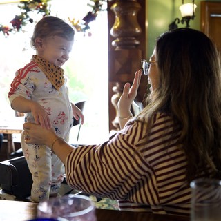 Mother Capturing Joyful Moment with Toddler at Home
