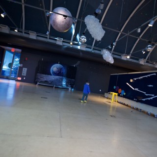 Child Explores Planetary Exhibition at Science Museum