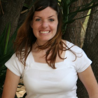 Smiling Young Woman Outdoors Among Tropical Foliage